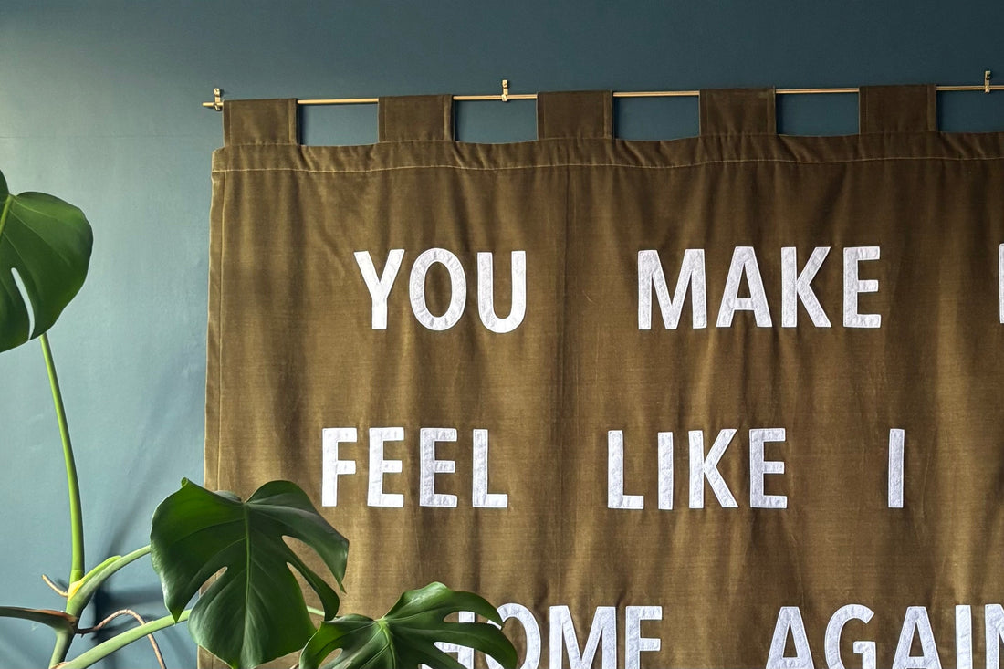 Green velvet banner on a blue wall