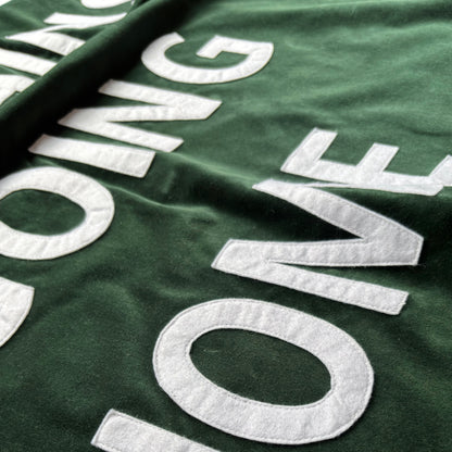 Close up of bottle green velvet handmade banner with white felt letters.