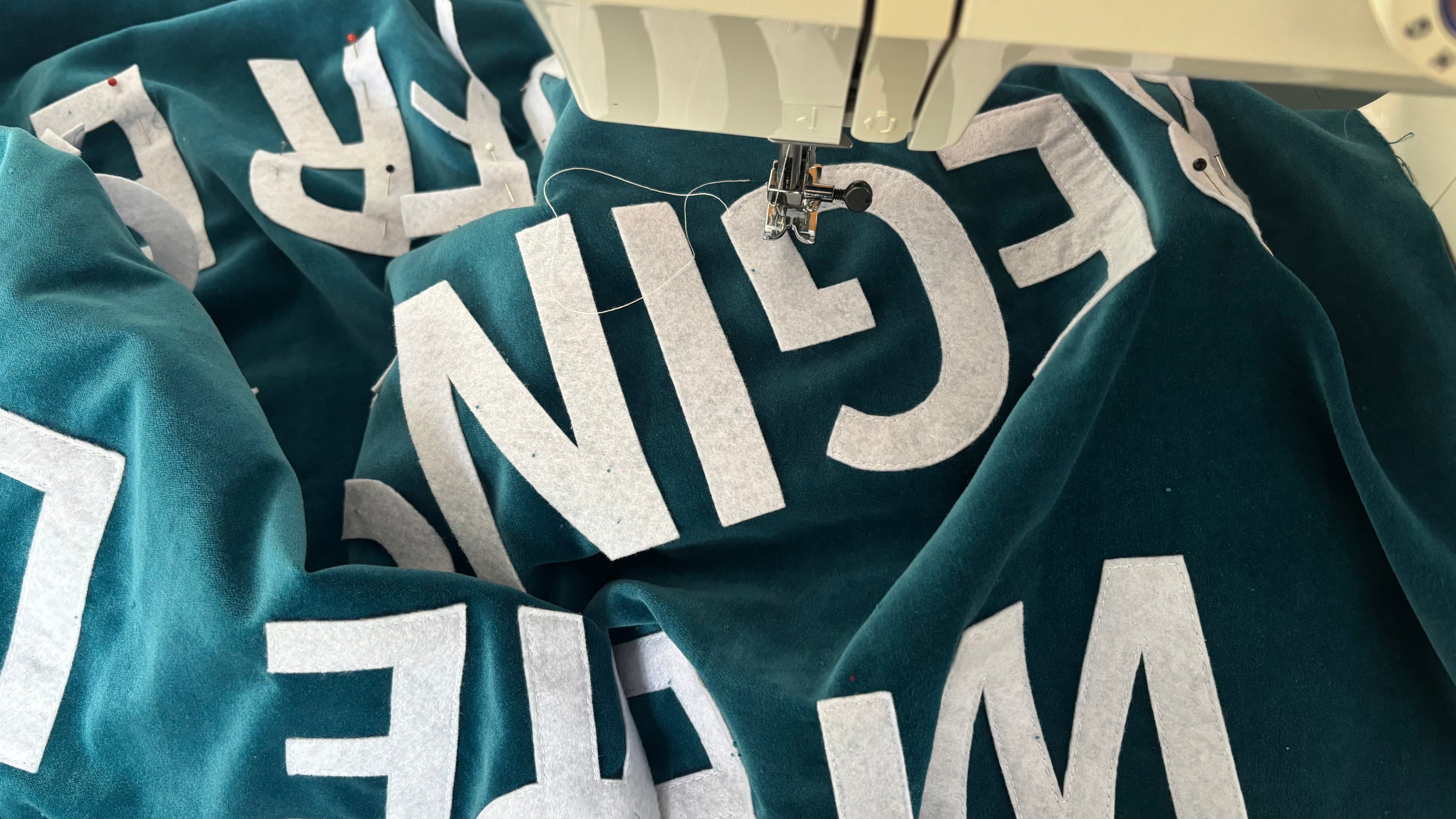 Teal custom velvet banner with white text handmade with a sewing machine