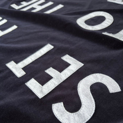 Close up of midnight blue velvet handmade banner with white felt letters.