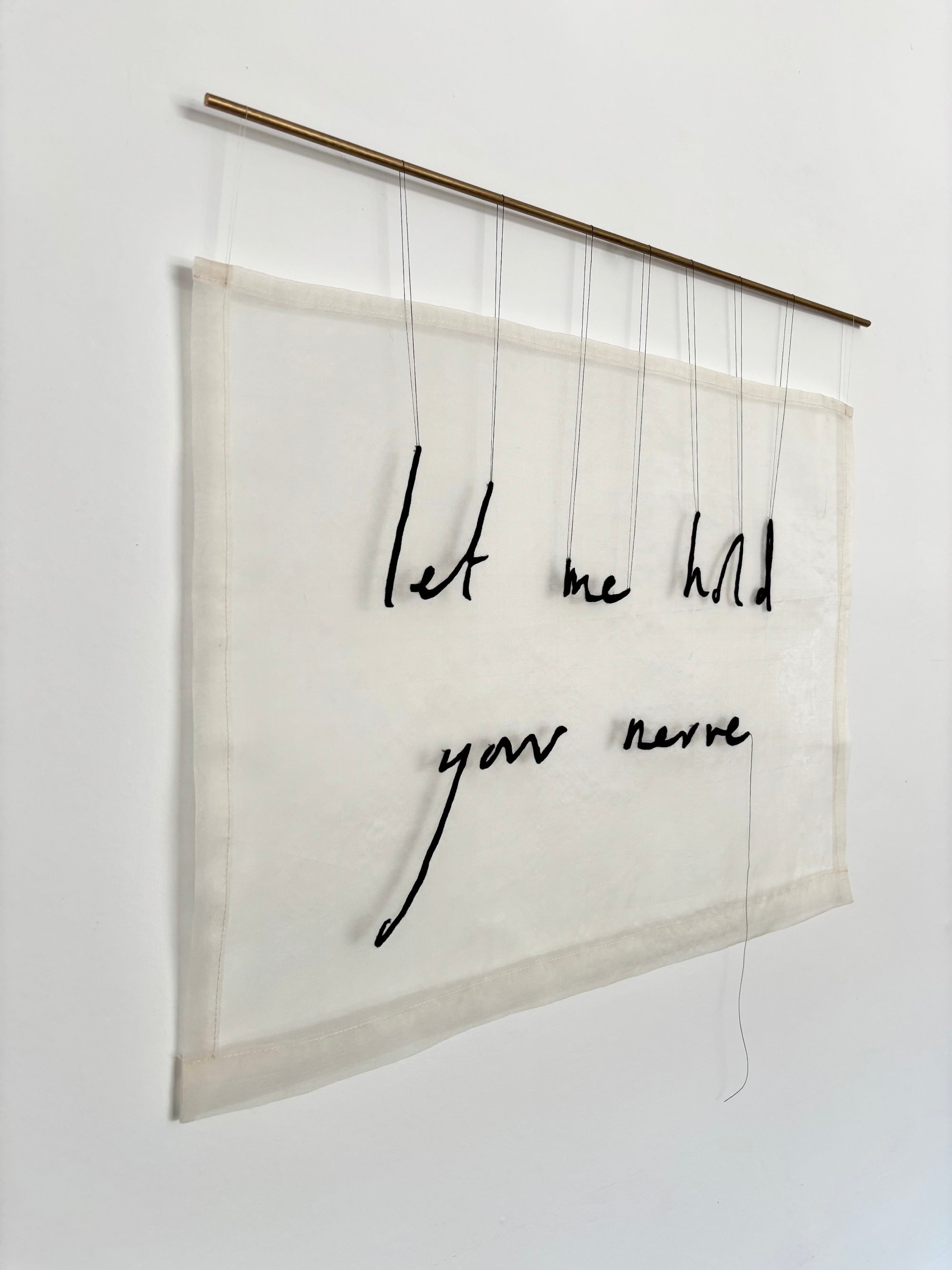 Textual art piece with 'Let me hold your nerve' on a white background