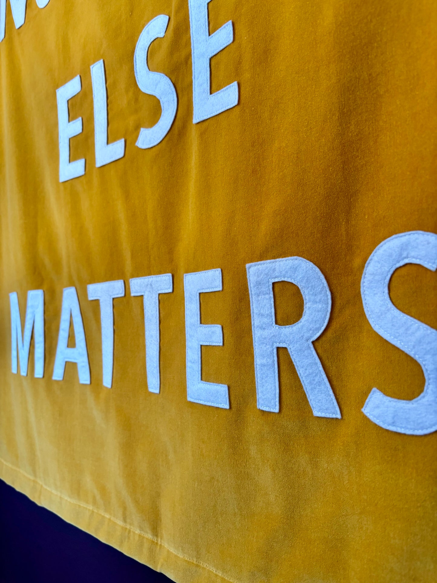 Yellow velvet banner with white text